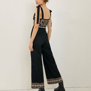 Anthropologie Black Wide-Leg Jumpsuit with Open Back and Decorative Hem
